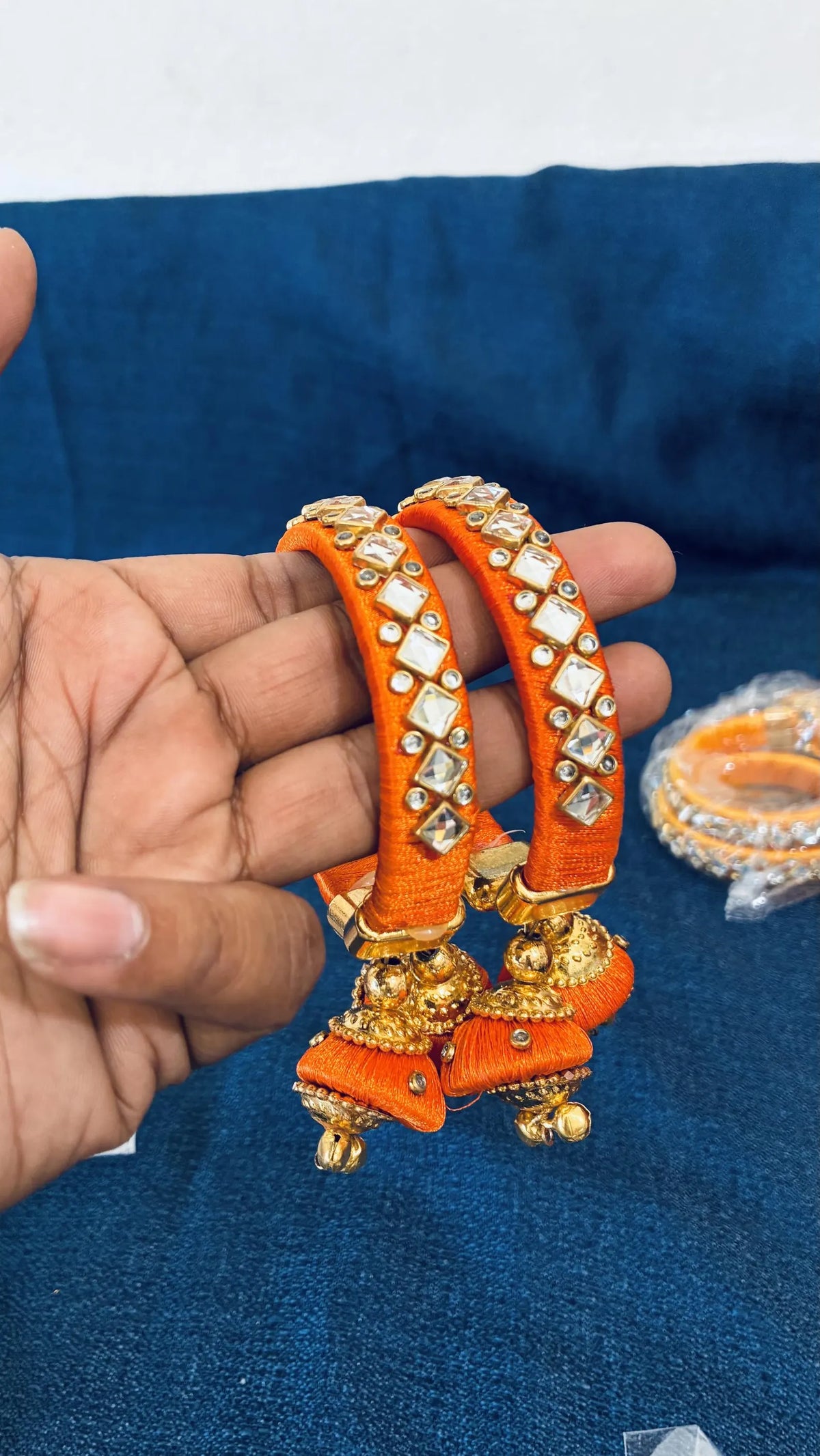 Orange Silk thread Kundan bangles
Set of two traditional Indian bangles
Gold-tone accents with dangling jhumka latkan
Multiple color options for different styling preferences
Push-open clasp and standard adult fit
Gift-ready jewelry for festivals and special occasions
Uphar Handicrafts