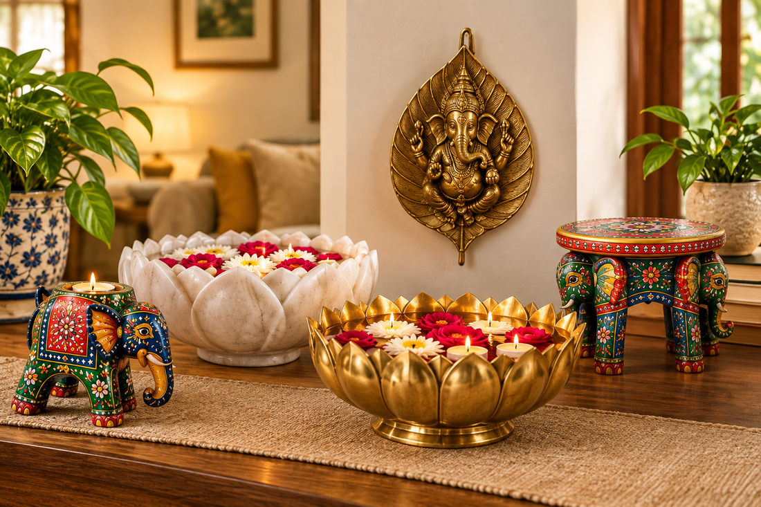Warm housewarming gift display featuring handcrafted Indian home decor, including a marble lotus bowl, brass lotus diya bowl, painted wooden elephant, Ganesh wall hanging, and elephant stool in a cozy living room Uphar Handicrafts