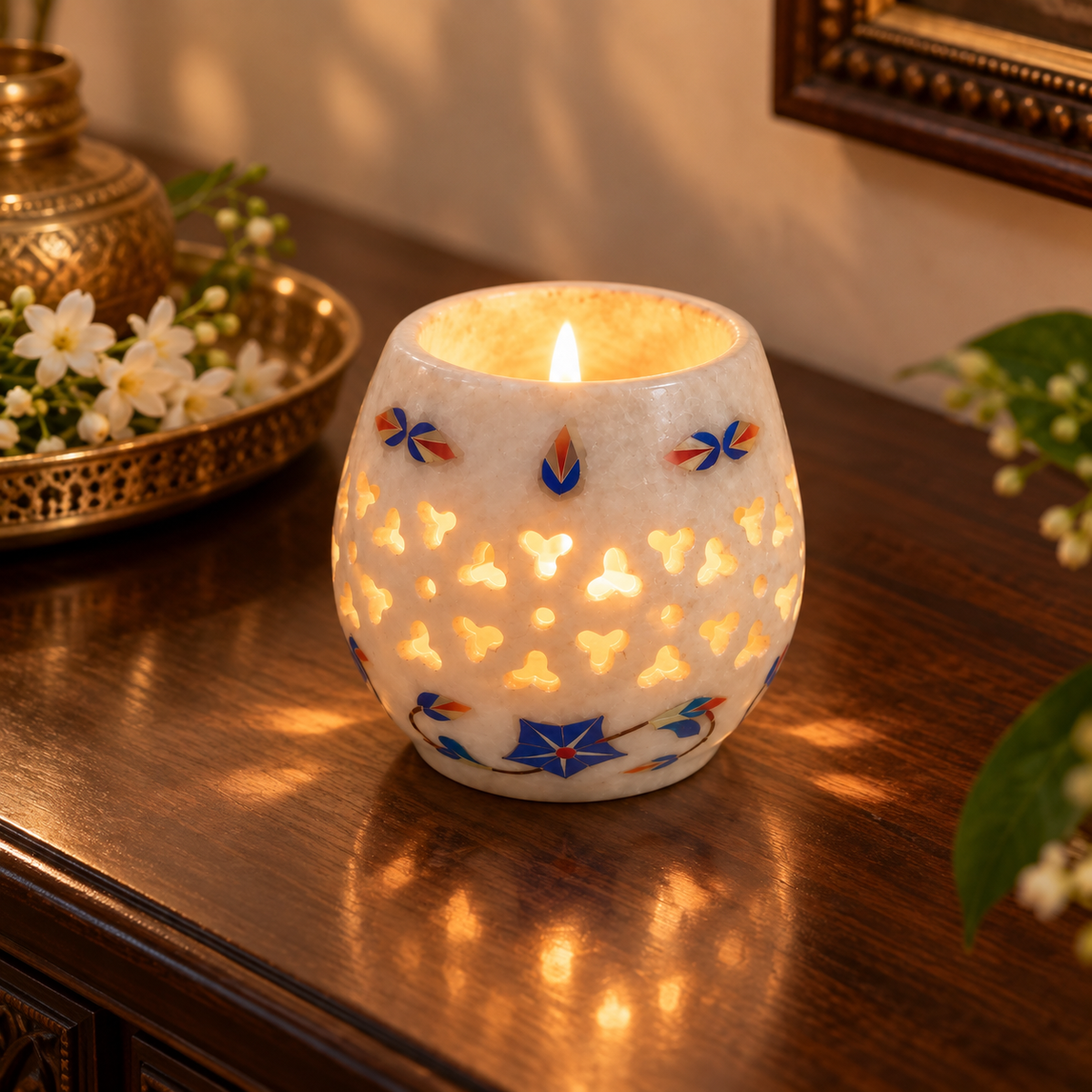 Indian marble tealight candle decor
White marble holder with polished finish
Round design with cut-out lattice detailing
Hand-inlaid floral border motifs
Three-inch marble tealight holder
Decorative accent for tables and bedside spaces
Uphar Handicrafts
