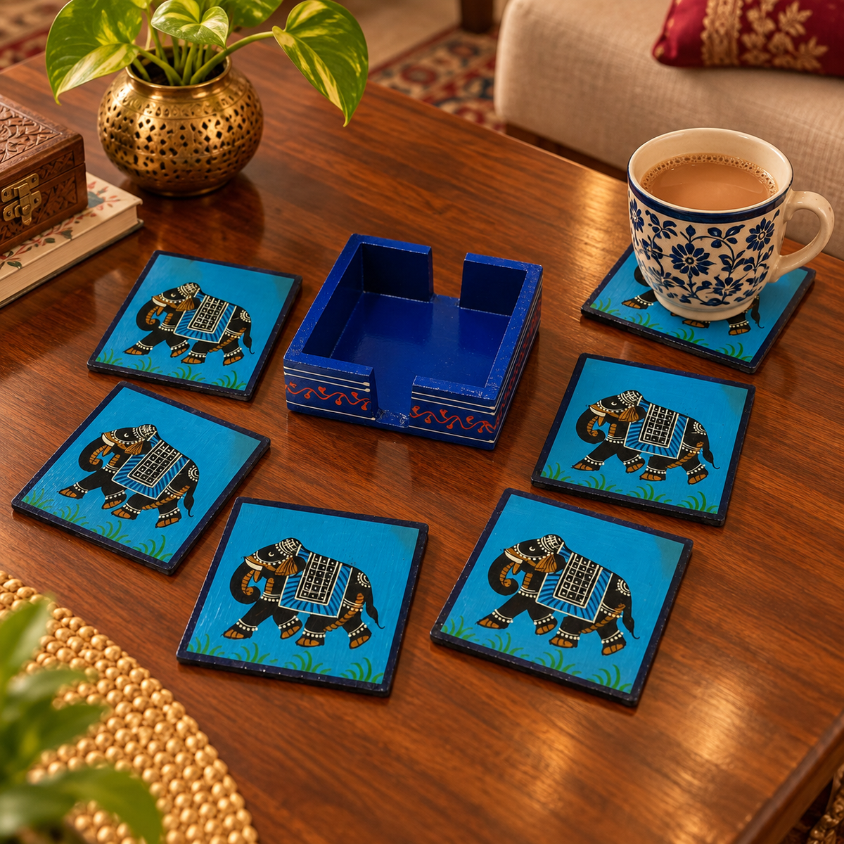 Blue hand-painted elephant coasters
Set of 6 wooden coasters with holder
Square coaster design with elephant motif
Glossy protective coat finish
Traditional Rajasthani-inspired table decor
Handcrafted Indian home accessory
Uphar Handicrafts