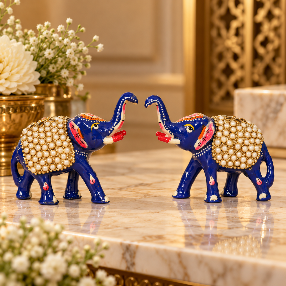 Set of two blue metal elephant figurines with hand-painted detailing
Glossy blue finish with red and white decorative accents
Standing elephants with raised trunks and pearl-style beaded saddles
Traditional Indian-inspired decorative elephant pair
Each elephant measures approximately 10 cm long, 5 cm wide and 9 cm high
Handcrafted showpieces for shelves, consoles and display cabinets
Uphar Handicrafts