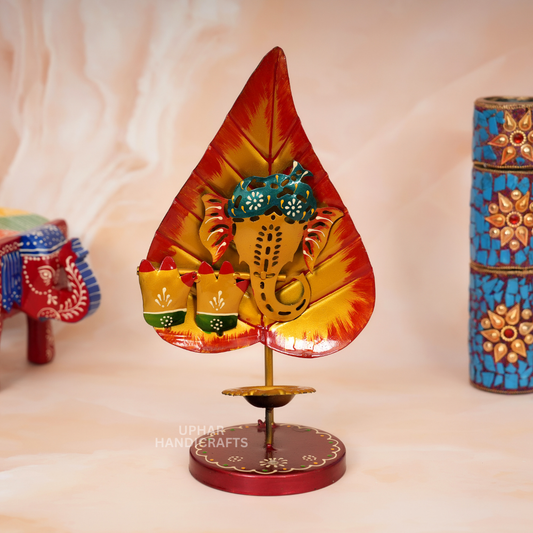 Colorful Ganesh Ji Pan Patta Tealight Holder
Hand-Painted Metal Diya Stand
Yellow Orange and Red Enamel Design
Ganesh Ji Leaf Shaped Pooja Decor
Traditional Indian Festival Decoration
Diwali and Ganesh Chaturthi Gift
Uphar Handicrafts