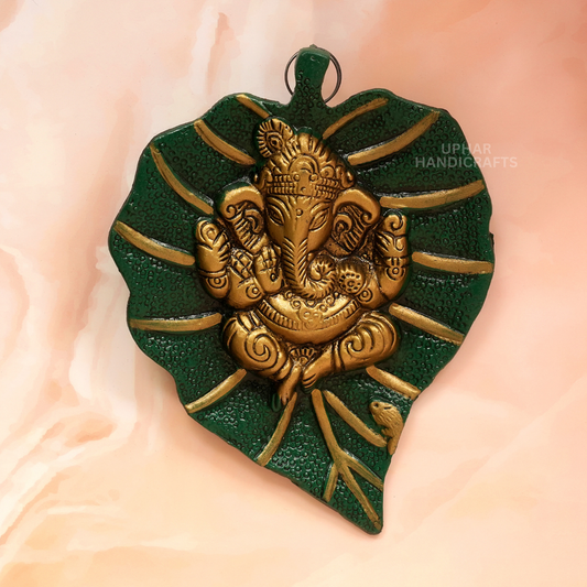 Ganesh Ji on Sacred Leaf Wall Decor
Green and Golden Metal Ganesha Art
Traditional Indian Spiritual Decoration
7x5 Inch Ganesh Wall Hanging
Pooja Room and Home Decor
Uphar Handicrafts