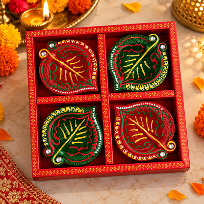 Green and red handmade clay diyas with decorative detailing
Traditional Indian diyas with floral hand-painted designs
Set of four hand-painted clay diyas for festive occasions
Decorative stone work on green and red diya
Handmade diyas for pooja and festive décor
Traditional clay diya gift set for Diwali
Uphar Handicrafts