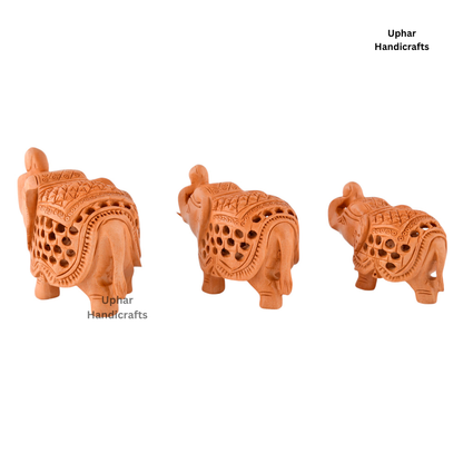Hand-Carved Jali Elephant Decor
Three Wooden Elephant Figurines
Intricate Traditional Indian Lattice Design
Natural Wood Artisan Craftsmanship
Boho Ethnic and Spiritual Home Decor
Compact Shelf Table and Altar Accent
Uphar Handicrafts