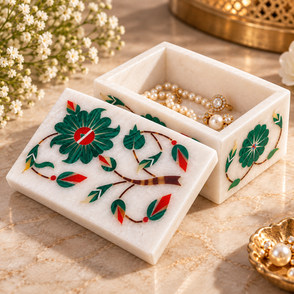 Hand-inlaid white marble box
Rectangular box with decorative lid
Floral stone motifs on the top
Leaf and vine detailing on the sides
Polished marble surface
Handcrafted Indian-inspired trinket storage
Uphar Handicrafts