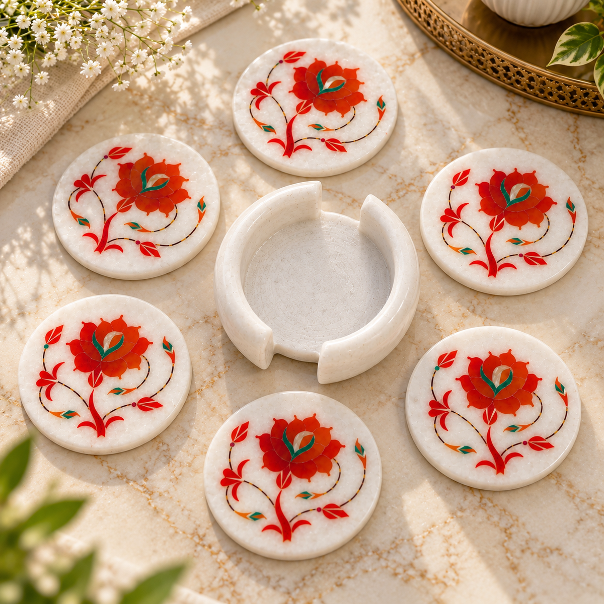 Handcrafted marble coaster set
White marble with floral inlay work
Round coasters for mugs and glasses
Floral vine pattern design
Hand-finished traditional table decor
Marble coaster set with holder
Uphar Handicrafts