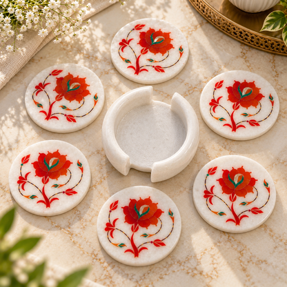 Handcrafted marble coaster set
White marble with floral inlay work
Round coasters for mugs and glasses
Floral vine pattern design
Hand-finished traditional table decor
Marble coaster set with holder
Uphar Handicrafts