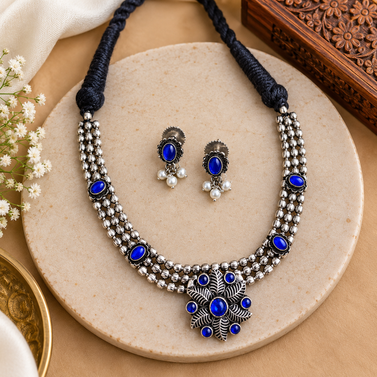 Handcrafted oxidized necklace and earrings set
Traditional Indian-inspired metal alloy jewelry
Antique silver-tone finish with decorative detailing
Stone and bead accents on the necklace
Matching earrings for a coordinated jewelry look
Suitable for weddings, parties and festive wear
Uphar Handicrafts
