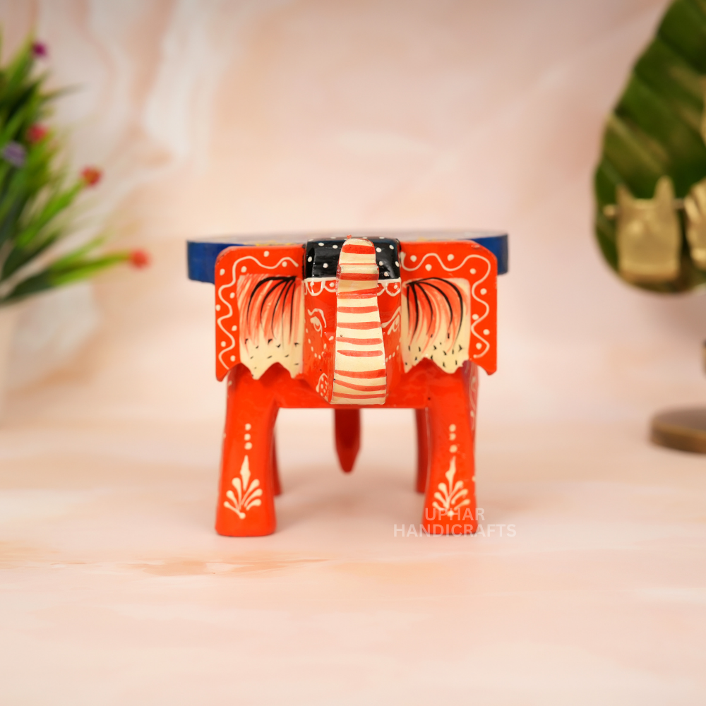 Indian Elephant Hand-Painted Stool
Blue Orange Traditional Folk Art Design
Solid Wood Decorative Craft
Unique Artisan Home Decor Piece
Meditation Space and Altar Decoration
Small Plant Stand and Shelf Accent
Uphar Handicrafts