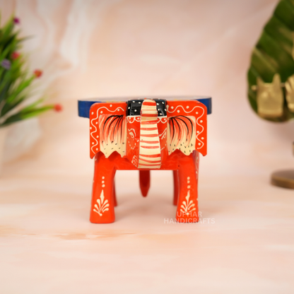 Indian Elephant Hand-Painted Stool
Blue Orange Traditional Folk Art Design
Solid Wood Decorative Craft
Unique Artisan Home Decor Piece
Meditation Space and Altar Decoration
Small Plant Stand and Shelf Accent
Uphar Handicrafts