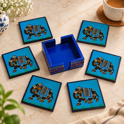 Indian hand-painted elephant coaster set
Six wooden coasters with matching holder
Red and blue design variants
Decorated elephant motif
Handcrafted traditional Rajasthani style
Wooden table decor and gifting set
Uphar Handicrafts