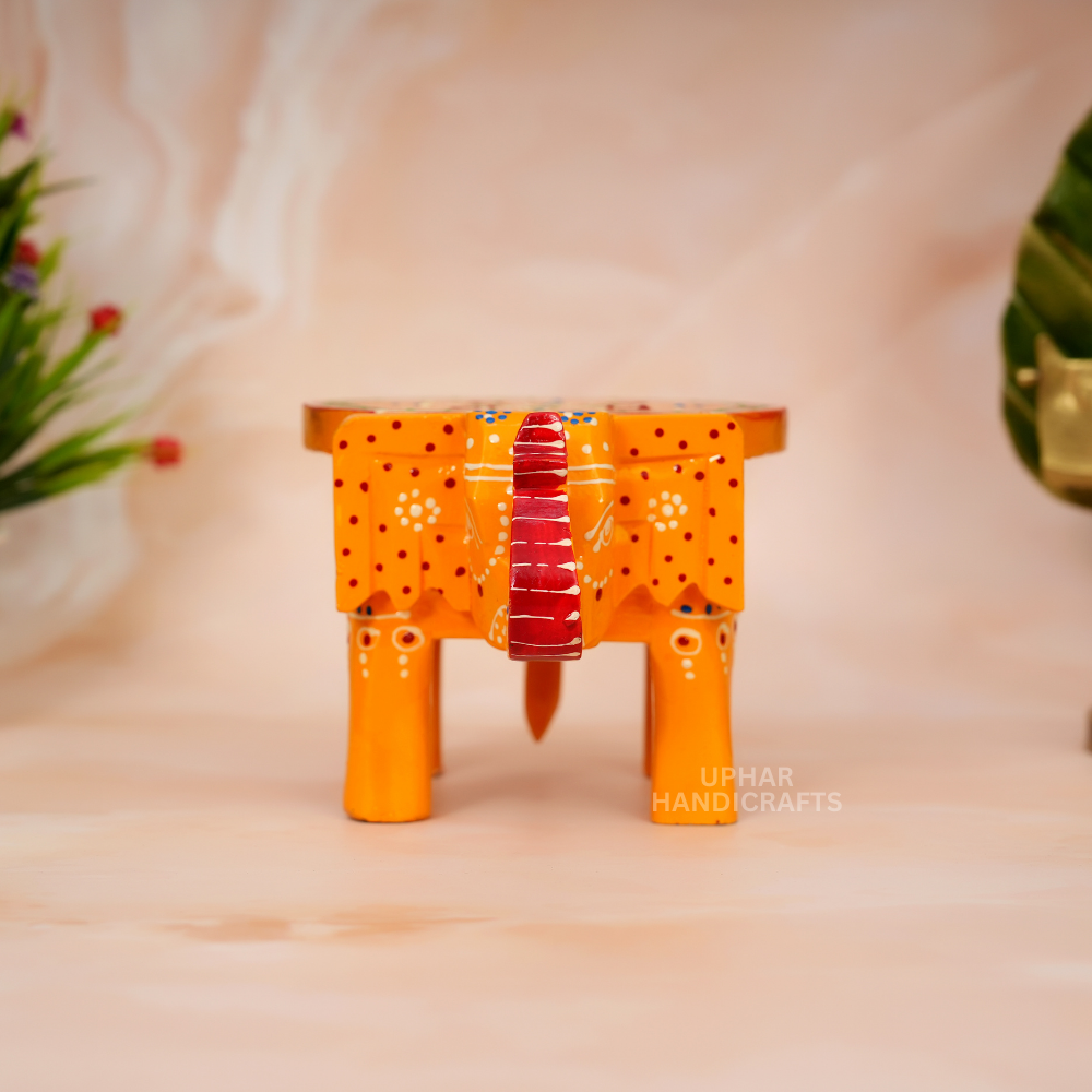 Indian Yellow Wooden Elephant Stool
Vibrant Hand-Painted Folk Art Design
Solid Wood Handmade Home Decor
Unique Artisan Decorative Furniture
Meditation Corner and Altar Accent
Small Plant Stand for Indoor Decor
Uphar Handicrafts
