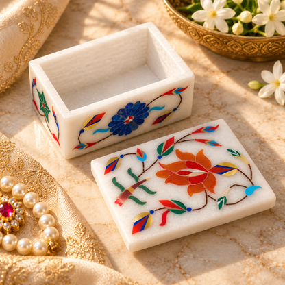 Marble box for jewelry and trinkets
White marble box with lid
Floral and leaf inlay work
Decorative vine motifs on the sides
Polished white marble finish
Traditional Indian-inspired storage accessory
Uphar Handicrafts
