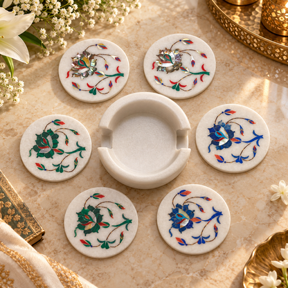 Marble coasters for tea and coffee cups
Set of 6 round white marble coasters
Matching marble holder included
Hand-inlaid floral vine design
Polished natural marble surface
Functional and decorative table accessory
Uphar Handicrafts