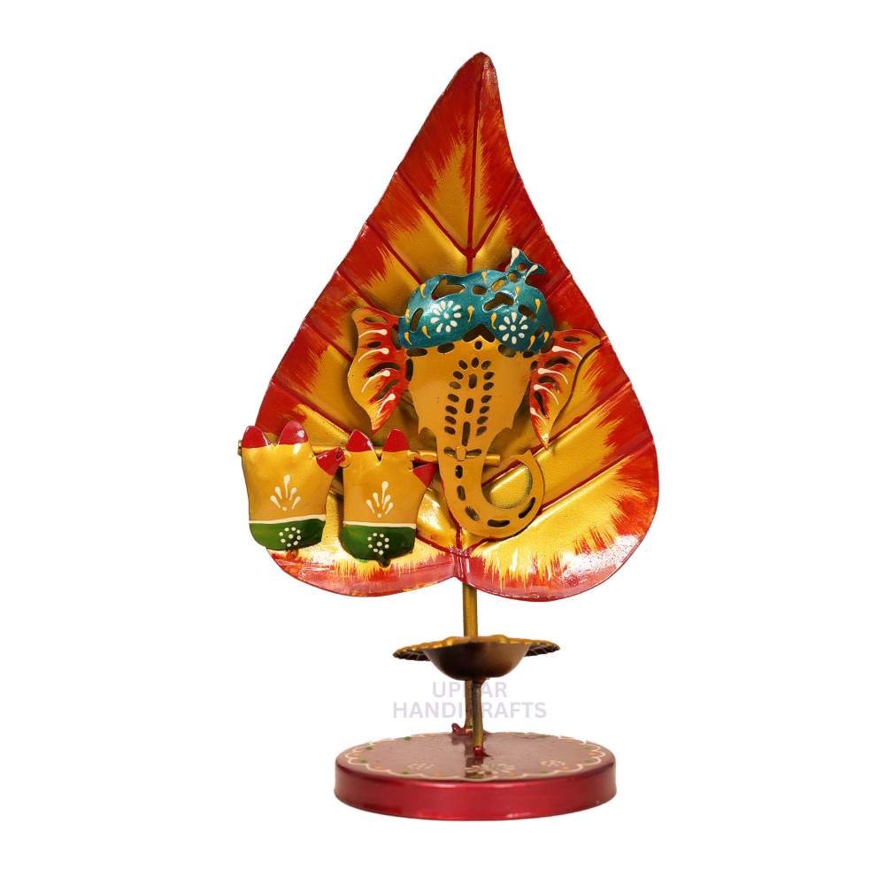Metal Ganesh Ji Leaf Diya Tealight
Hand-Decorated Pan Patta Design
Colorful Enamel Traditional Artwork
Gold Tone Tea Light Holder
Indian Festival and Pooja Decoration
Diwali Housewarming and Wedding Gift
Uphar Handicrafts
