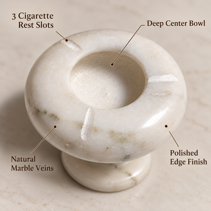 Modern round ashtray in polished white marble
Natural grey veins across the stone surface
Deep circular bowl with three rest slots
Pedestal base adds height to the design
Contemporary style for desks and bar carts
Hand-finished marble tabletop accessory
Uphar Handicrafts