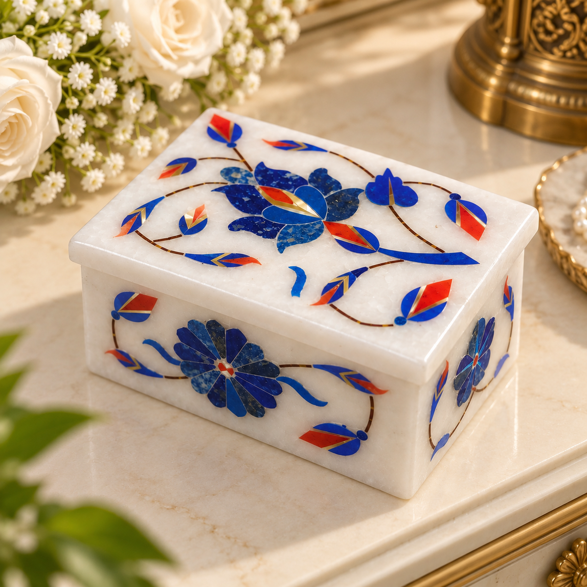 Mughal-inspired marble trinket box
White marble with stone inlay work
Rectangular box with decorative lid
Floral leaf and vine motifs
Handcrafted and hand-inlaid details
Traditional Indian decorative accessory
Uphar Handicrafts