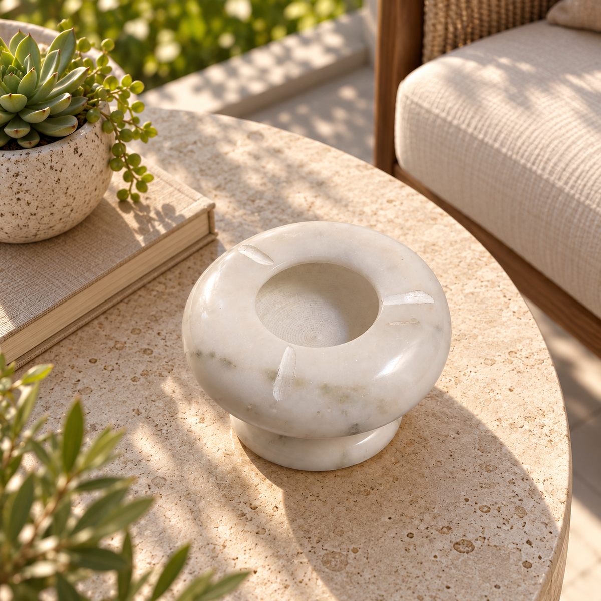 Natural marble ashtray for tabletop use
White stone with distinctive grey veining
Round design with three cigarette rest grooves
Deep bowl and raised pedestal construction
Handcrafted and hand-finished marble accessory
Suitable for coffee tables and outdoor tables
Uphar Handicrafts