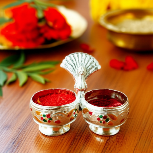 Peacock Kumkum Rice Holder
Silver-Toned Metal Puja Accessory
Dual Bowl Roli and Akshat Holder
Colorful Enamel Peacock Design
Traditional Indian Ritual Decor
Diwali and Wedding Return Gift
Uphar Handicrafts