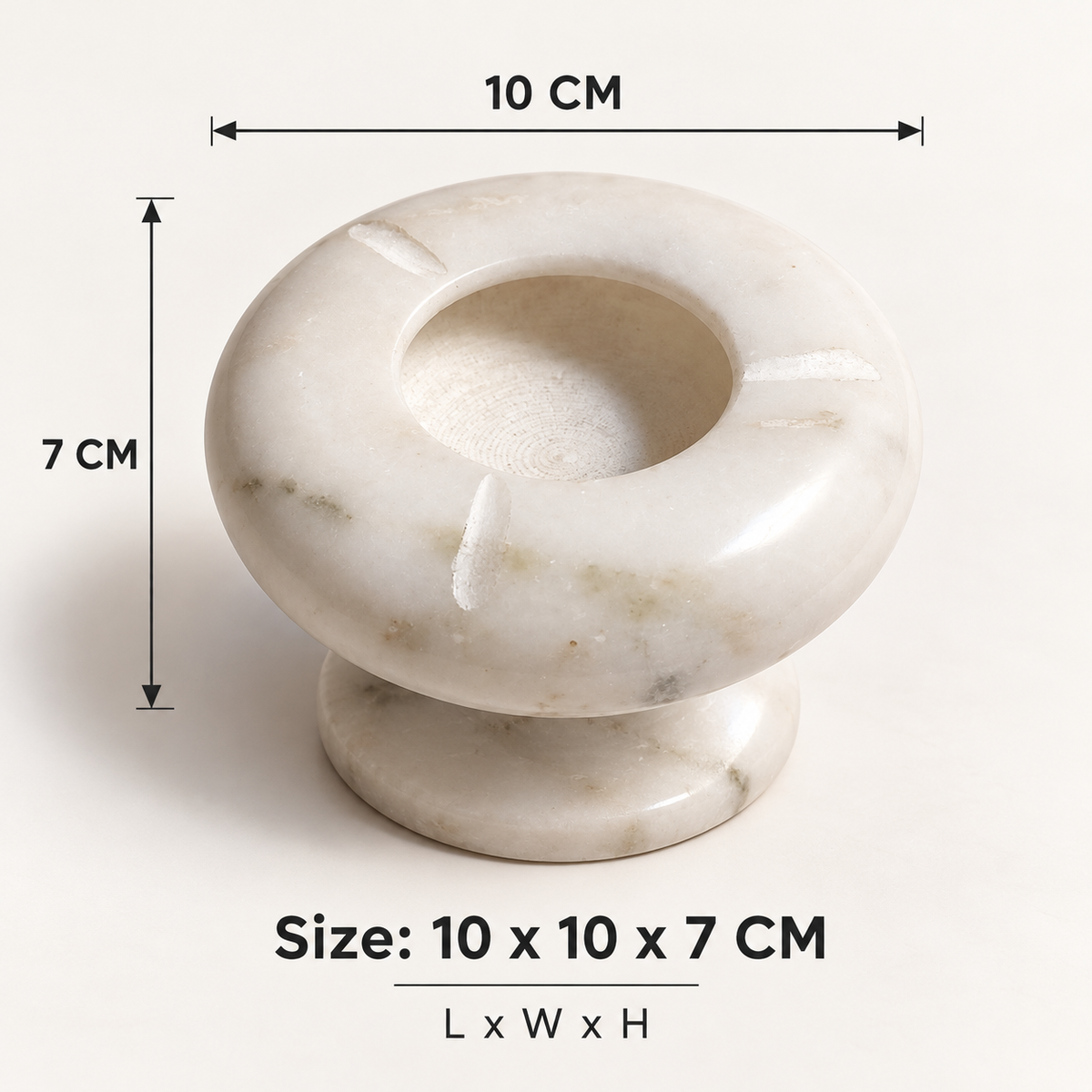 Polished natural marble ashtray with pedestal base
Round bowl-shaped top with a deep center
Three notched slots for resting cigarettes
White marble surface with grey natural patterns
Hand-finished design with a raised bottom
Modern accent for patio tables and desks
Uphar Handicrafts