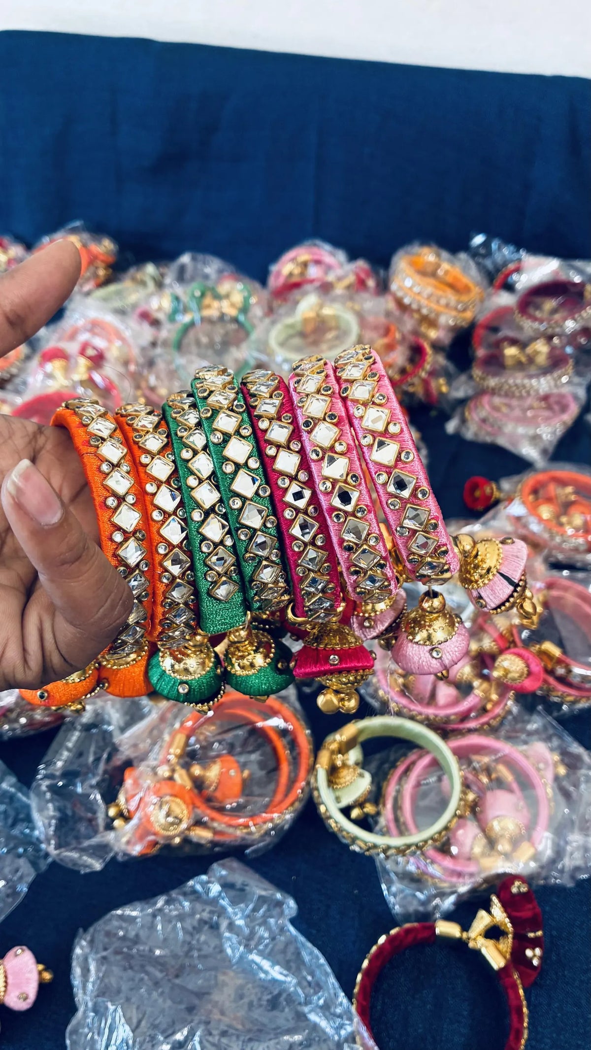 Silk thread bangles with decorative Kundan stones
Gold-tone accents across the traditional design
Jhumka latkan adds a dangling decorative element
Set of two metal-base bangles
Silk thread wrapping with a handcrafted look
Traditional jewelry for festive styling
Uphar Handicrafts