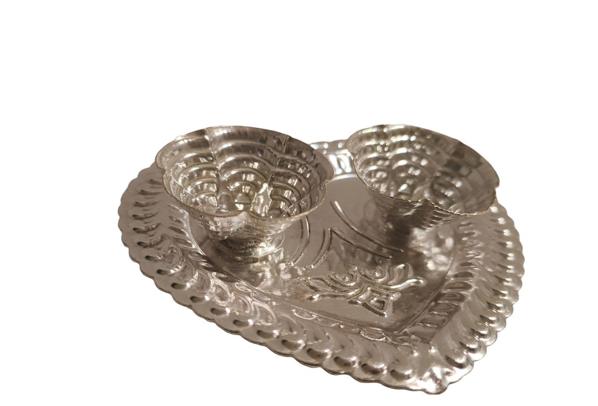 Silver Kumkum Chawal Holder Plate
German Silver Indian Pooja Accessory
Dual Bowl Roli and Rice Holder
Elegant Heart Pattern Embossed Design
Traditional Mandir and Festival Decor
Diwali Return Gift and Housewarming Gift
Uphar Handicrafts